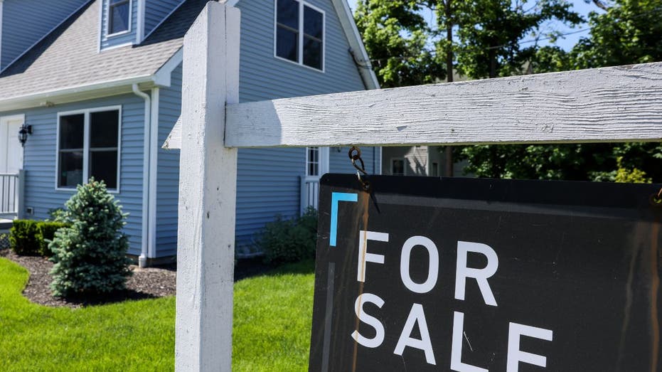 for sale sign in front of house